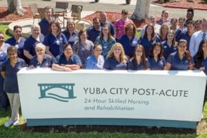 The employees standing behind the Yuba City sign